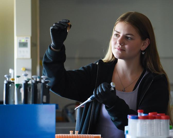 Summer research program student in a chemistry lab. 