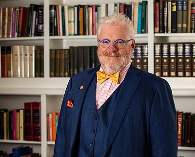 Susquehanna University President Jonathan Green posed in front of a bookcase